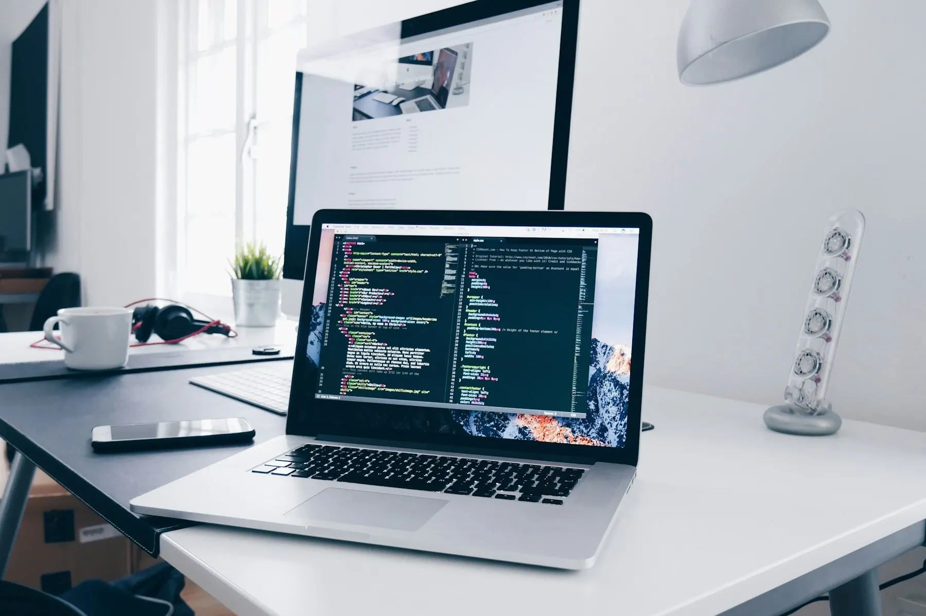 A developer reviewing front-end code on a laptop