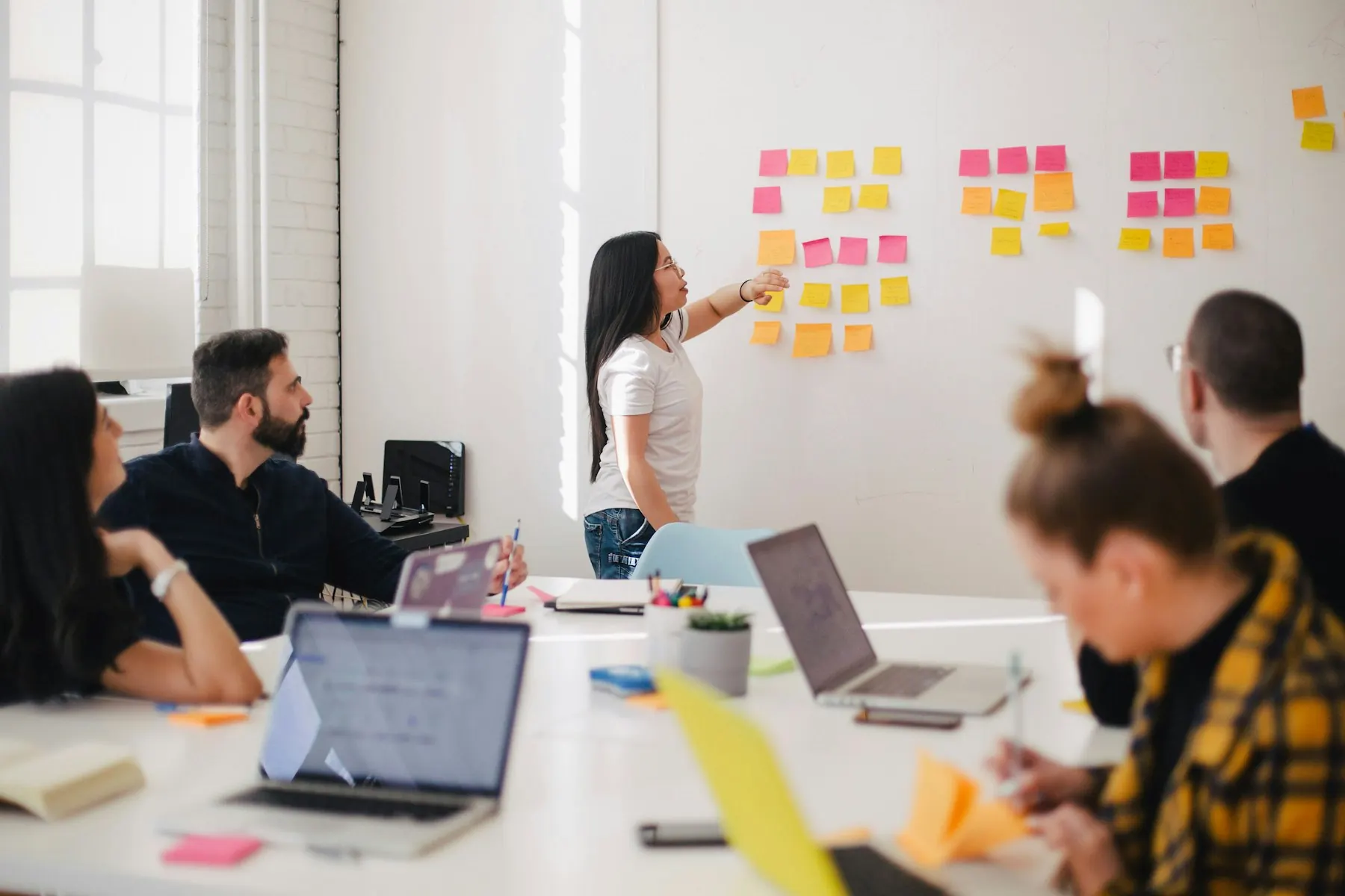 A small business team talking around a table in a bright office